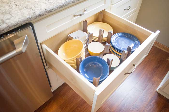 The kitchen drawer with small dish plates and bowls