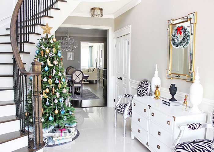 Christmas tree beside stairs