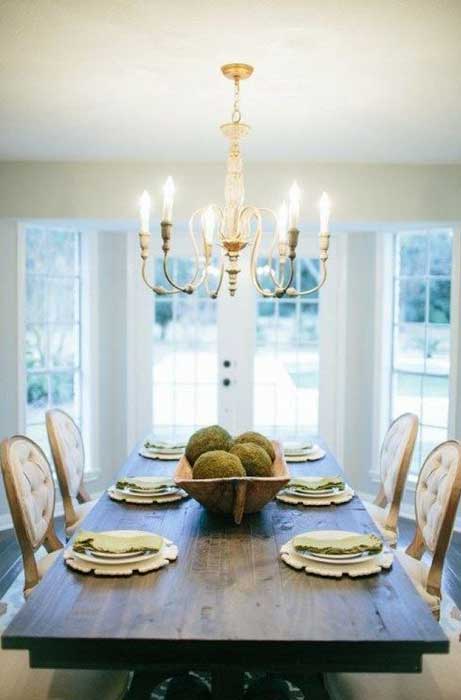 Wooden dining table with overhead light fixture in Madison, WI