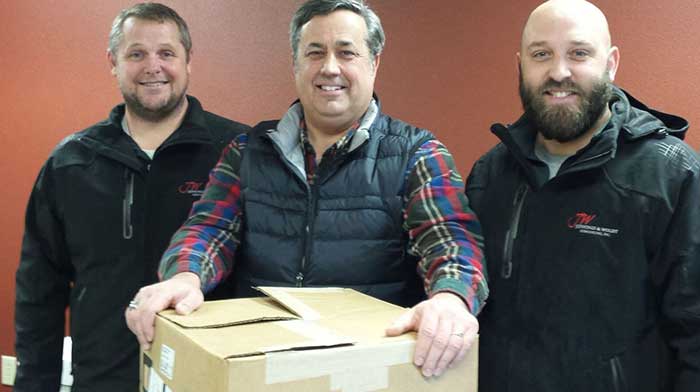 JW Interiors employees taking a photo together at food drive in Madison, WI