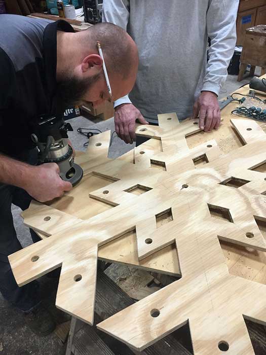 Man making wood snowflake